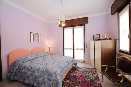 a bedroom with a bed and a refrigerator at B&B Il Fragolo in Verona