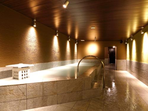 a bathroom with a bath tub in a building at Hotel Abest Osu Kannon Ekimae Hane no Yu in Nagoya