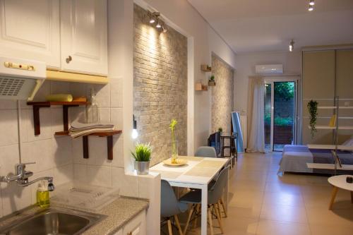 a kitchen and living room with a sink and a table at Cozy Studio in Central Glyfada in Athens
