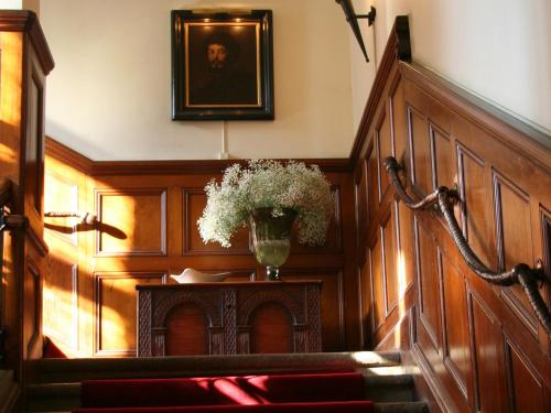 a hallway with a vase of flowers on a table at Södertuna Slott in Gnesta