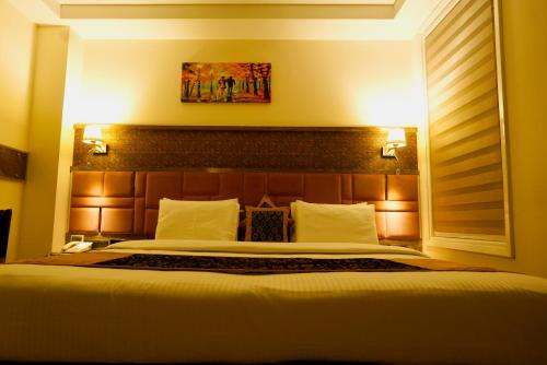 um quarto com uma cama grande num quarto em THE SINGH EMPIRE, New Delhi em Nova Deli