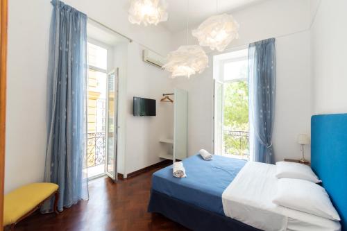 ein Schlafzimmer mit einem blauen Bett und einem Fenster in der Unterkunft Areamare in Neapel