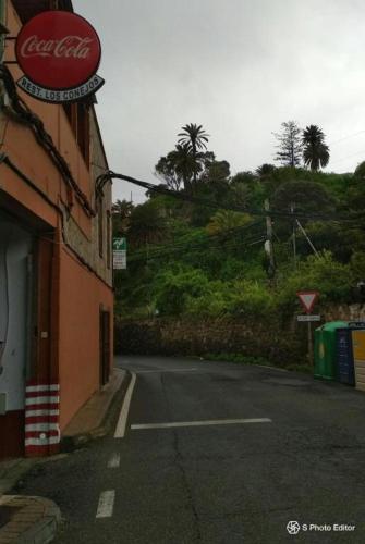 a building with a cocacola sign on the side of a street at Residencia Los Conejos - Bike & Motorbike in Las Palmas de Gran Canaria
