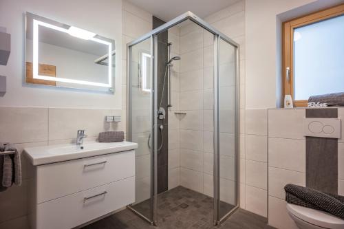 a bathroom with a shower and a sink at Apart Alpenrose in Schwendau