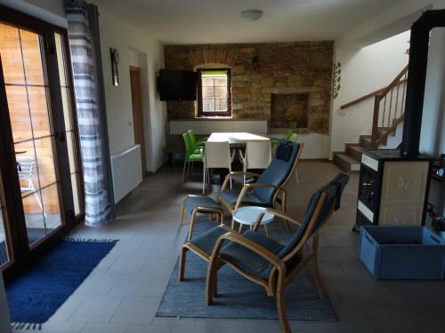 a living room with a table and chairs and a dining room at Ubytování u kostela, SEDLO 12os in Číměř