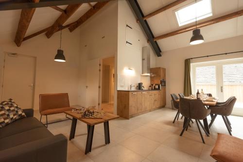 a living room with a couch and a table at Hoeve Kroonen in Schin op Geul