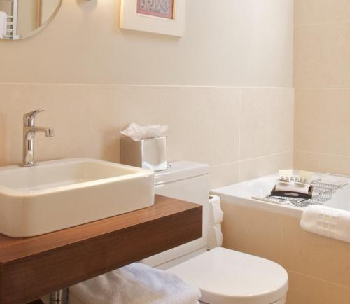 a bathroom with a sink and a toilet at Lords Of The Manor in Upper Slaughter