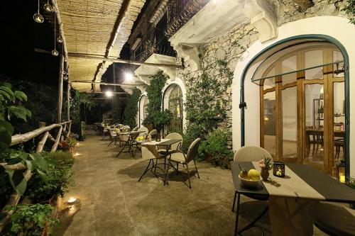 a patio with tables and chairs in a building at Colle dell'Ara in Positano