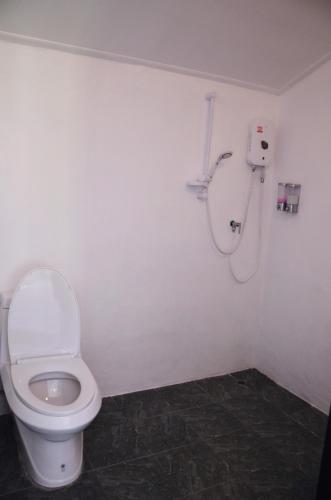 a bathroom with a toilet and a shower at Nok Chan Mee Na in Chom Thong