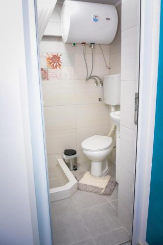 a small bathroom with a toilet and a sink at Korzo Prenoćište in Novi Pazar