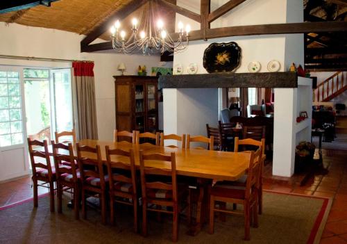 a dining room with a wooden table and chairs at Ribatejo Villa in Benfica