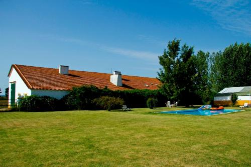 a yard with a pool in front of a house at Ribatejo Villa in Benfica