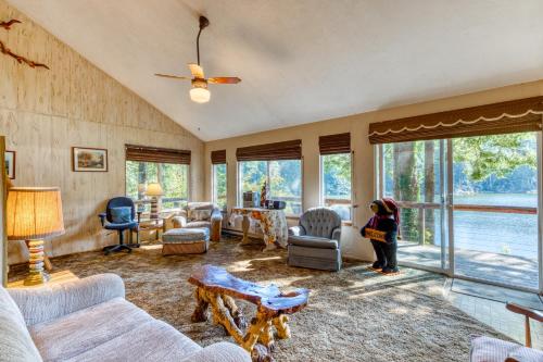a living room with a lot of furniture and windows at Rustic Retreat on Mercer Lake in Florence