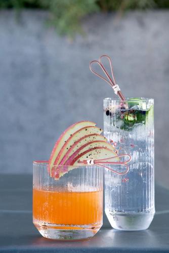 a glass jar with a spoon in it next to a drink at Thalassa Boutique Hotel - Adults Only in Lassi