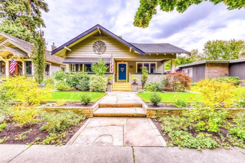 a yellow house with a yellow door and a yard at The Harrison House in Boise