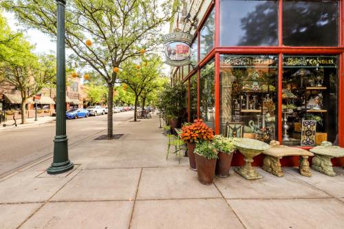 a sidewalk with a bench and tables and a store at The Harrison House in Boise