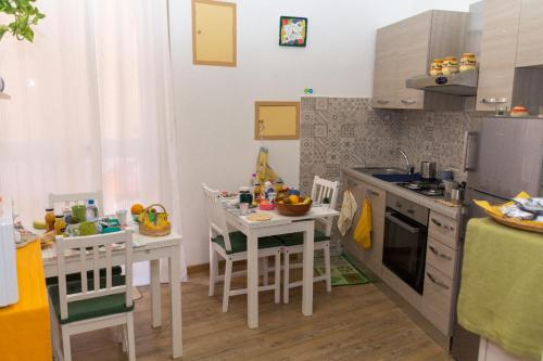 a kitchen with a table and chairs and a kitchen with a counter at La Casa dei Nonni in Livorno