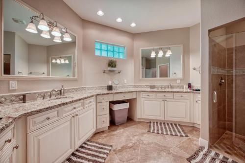 a bathroom with two sinks and a shower at Villa Holiday Sunrise in Cape Coral