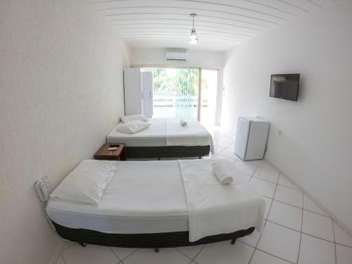 מיטה או מיטות בחדר ב-Pousada Marina Porto