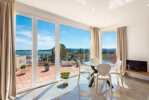 a living room with a table and chairs and a large window at Archinuè in Siracusa