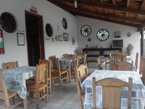 a dining room with tables and chairs in a room at Pousada Estrela Matutina in Pirenópolis