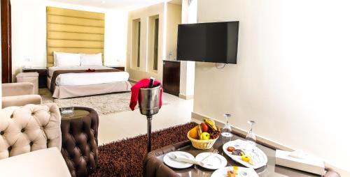 a living room with a bed and a table in a room at Seagull Beach Resort - Families and Couples Only in Hurghada