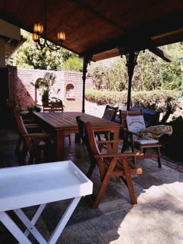 a wooden table and chairs under a pavilion at Umoya in Hilton