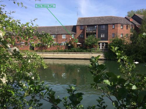 a body of water in front of a brick building at The River Flat in Oxford