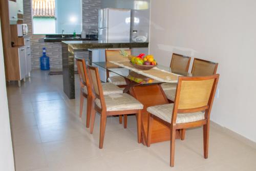 a kitchen with a dining room table and chairs at Casa Rodrigues in Trancoso