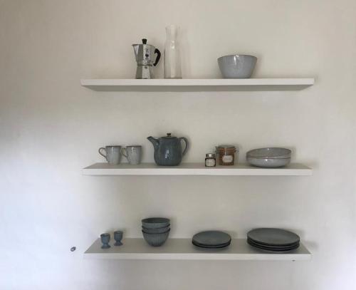 a shelf with bowls and other items on it at Studio Minerva in Antwerp
