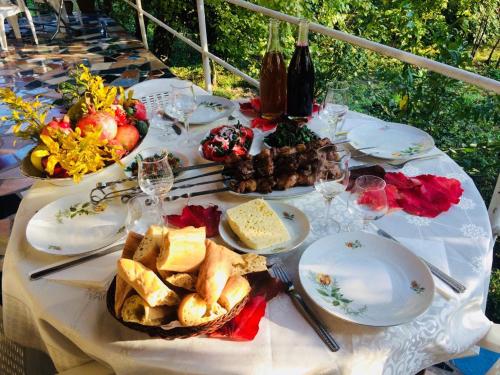 a white table with plates of food on it at Green House in Lagodekhi