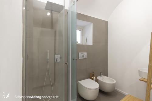 a bathroom with a shower and a toilet and a sink at Le Dimore Degli Archi Catania in Catania