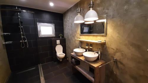 een badkamer met 2 wastafels, een toilet en een douche bij B&B Casa Trankilo in Kralendijk