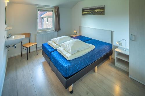 En eller flere senge i et værelse på Recreatie Landgoed Terlingerhoeve