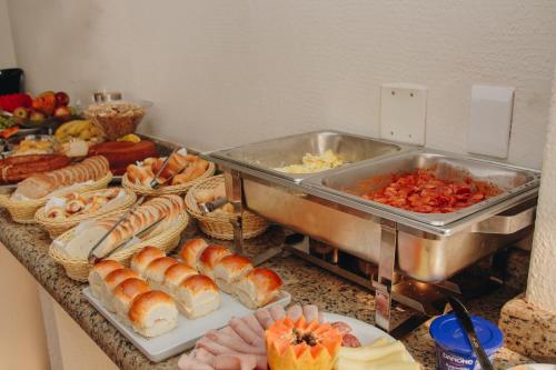 a buffet of food with croissants and other foods at SAMIR HOTEL COMFORT in Porto Velho