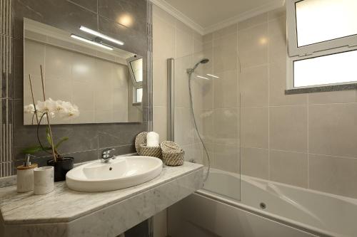 a bathroom with a sink and a mirror at Peace Haven ll in Calheta