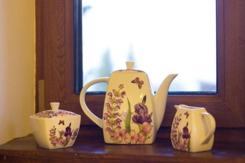 a tea pot and two cups sitting on a table at Agropensiunea Mara in Mărişel