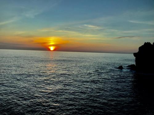 a sunset over the ocean with the sun at Cà Lea Beach House in Monterosso al Mare