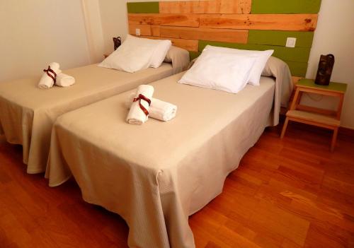 a hotel room with two beds and a table at Twenty Seven Degrees Las Palmas in Las Palmas de Gran Canaria