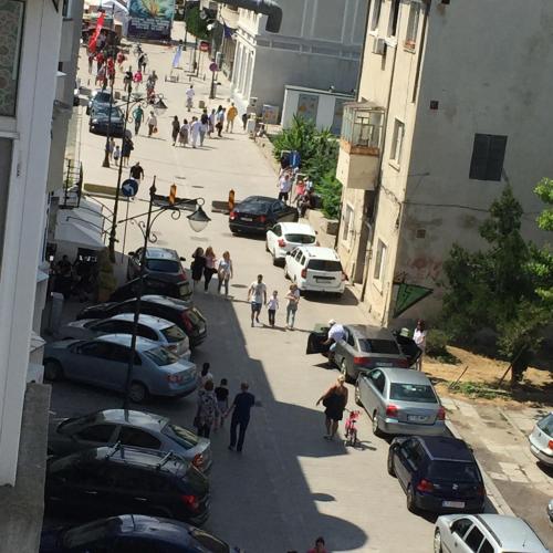 a group of people walking down a street with cars at Great Black Sea View in Constanţa