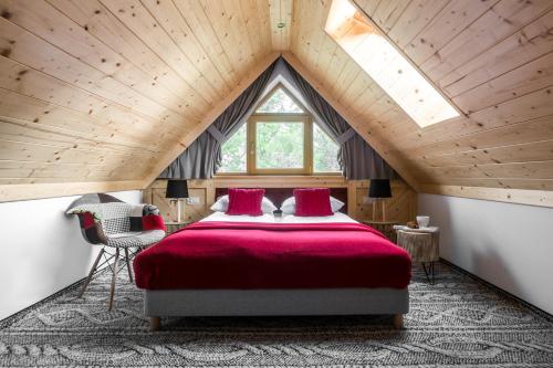 a bedroom with a large red bed in a attic at Willa pod Orłem - Zakopane in Zakopane