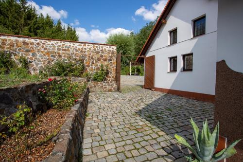 a stone walkway next to a building at Hájovna Hněvnice in Hněvnice