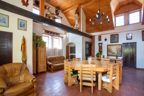 a living room with a wooden table and chairs at Hájovna Hněvnice in Hněvnice