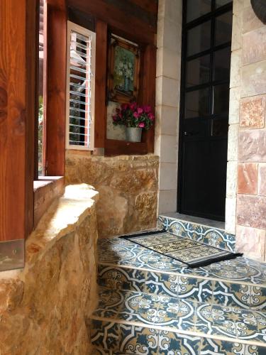 an entrance to a house with a tile floor and a door at Zimer Al-Bayt in Mas'ade