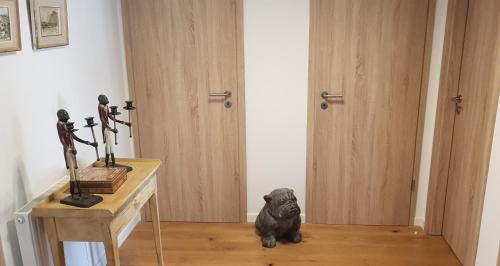 a black dog sitting on the floor in a room at Appart Hotel Nivelles in Nivelles