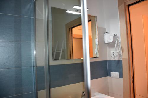 a bathroom with a shower and a mirror at La Pescarella in Ginosa