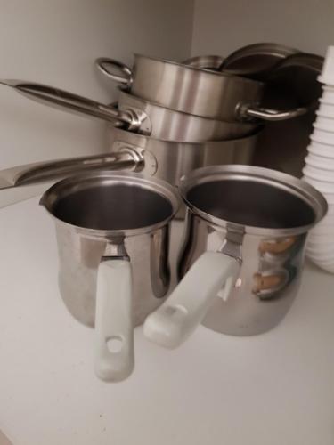 a kitchen counter with two pots and pans at Apartment GEA 18 in Novi Sad