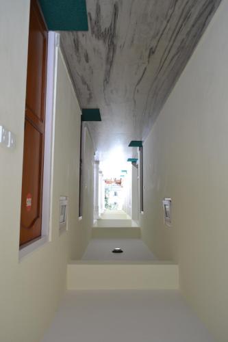 a hallway in a building with a white ceiling at Hotel Global Inn in Pokhara
