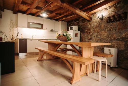 a kitchen with a wooden table in a room at Casa Ferreira in Sabugueiro