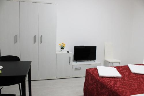 a white room with a tv and a bed at La Locanda dell'Olmo in Milan